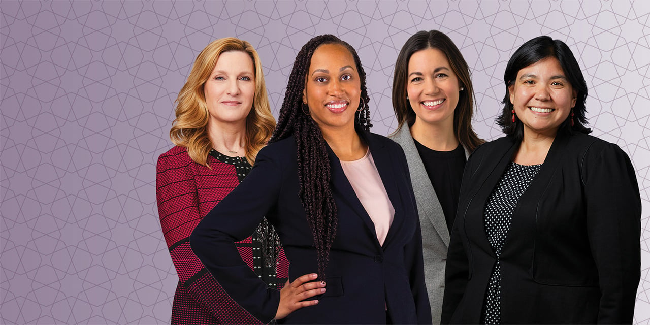 Four professional women with a purple background.